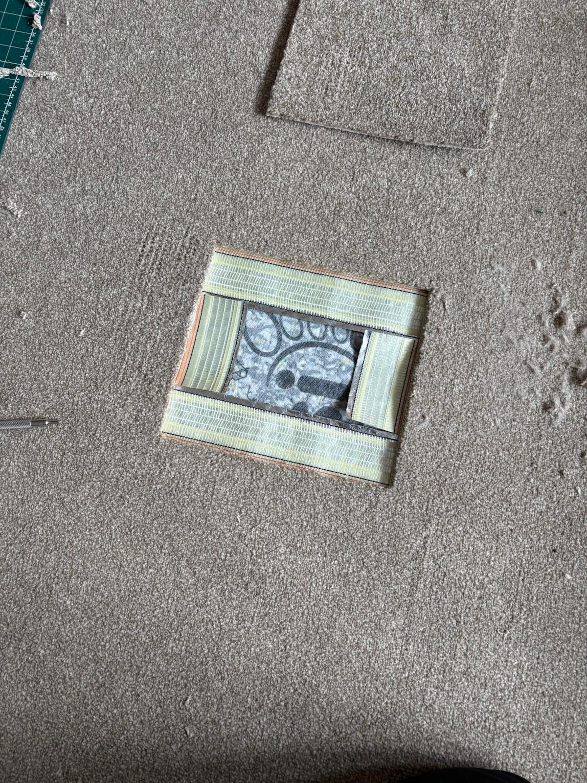 Completed carpet repair result showing invisible patch